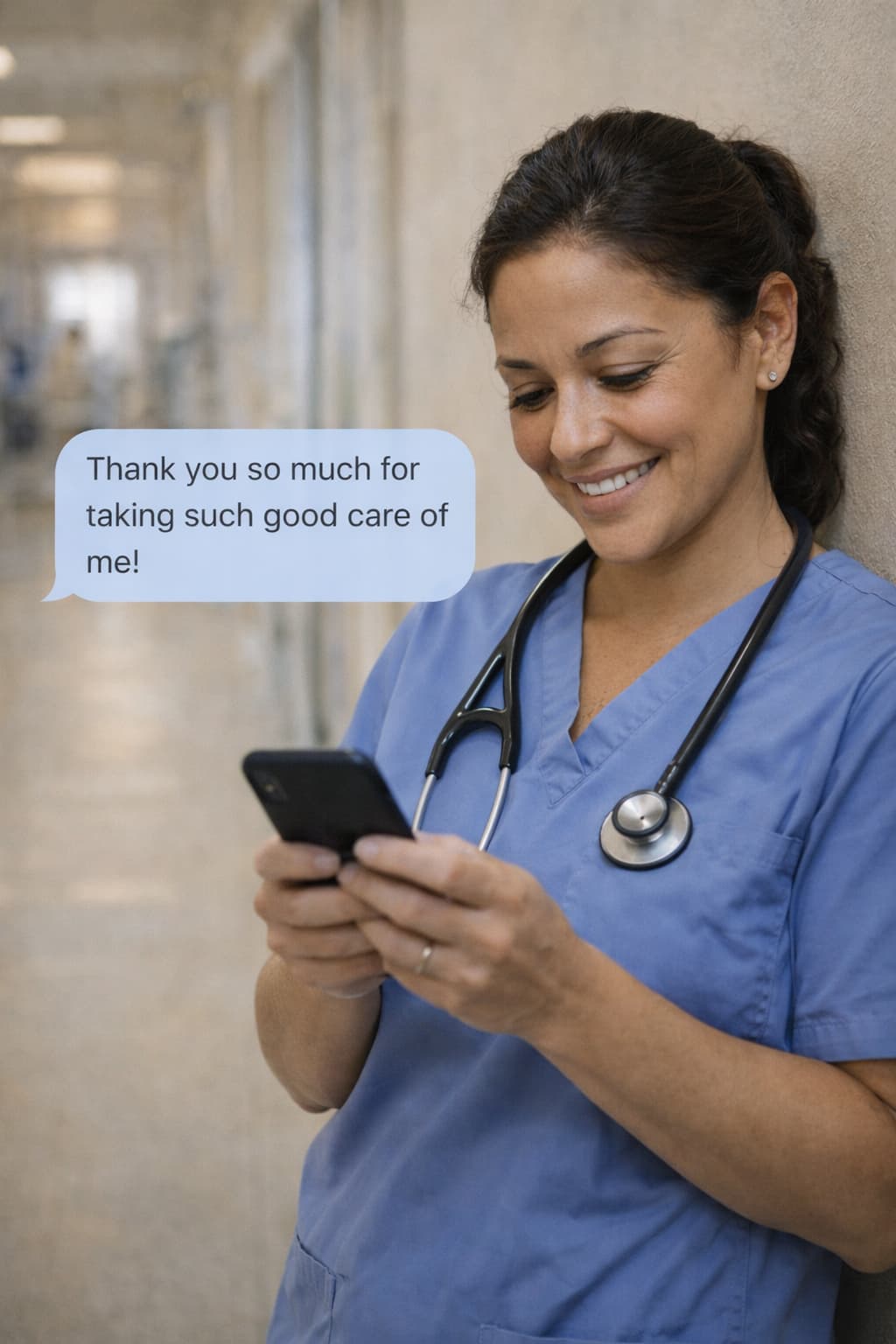 Nurse reading a patient thank-you message on her phone during a shift